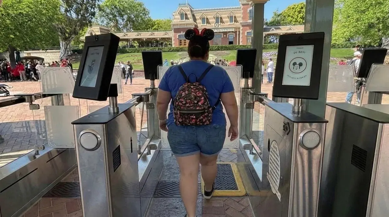 Plus size guest entering Disneyland through the Main Street USA turnstiles.