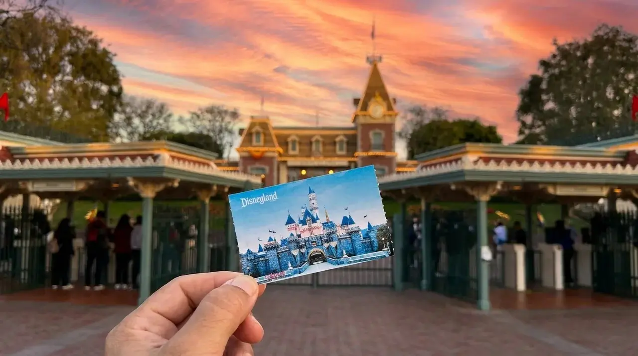 Disneyland Ticket in front of The Disneyland Resort Entrance with Sunset.