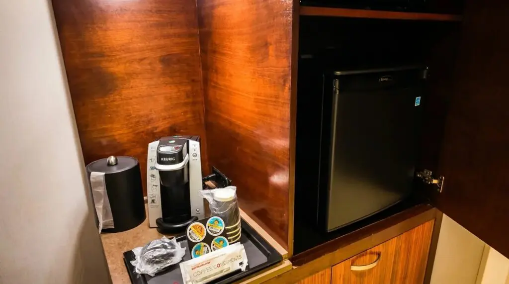 Courtyard by Marriot Keurig coffee maker and mini fridge in room.