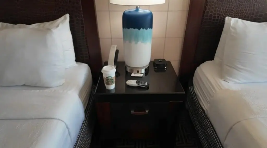Two queen layout with night stand in the center of the two beds.