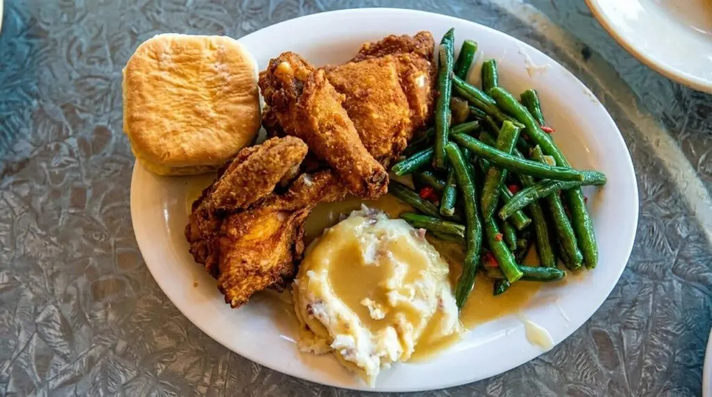 Fried chicken plate at Plaza Inn at Disneyland Resort with Mashed Potatoes, Green Beans and a Biscuit.