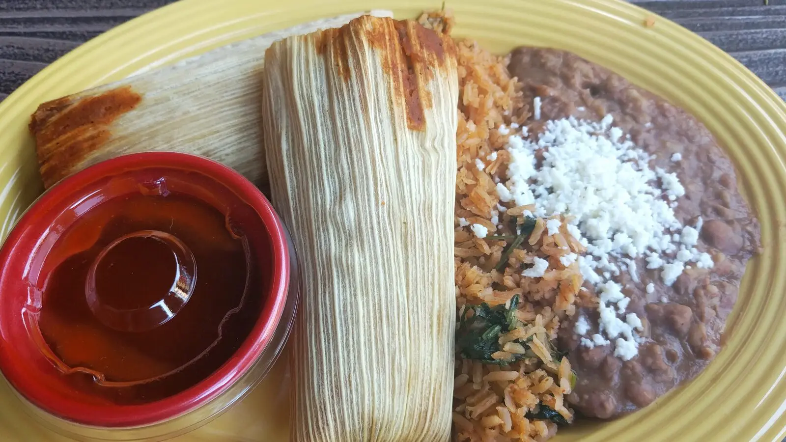 Tamale plate with Spanish rice, refried beans, cotija cheese and red sauce served at Rancho del Zocalo Restaurante at Disneyland