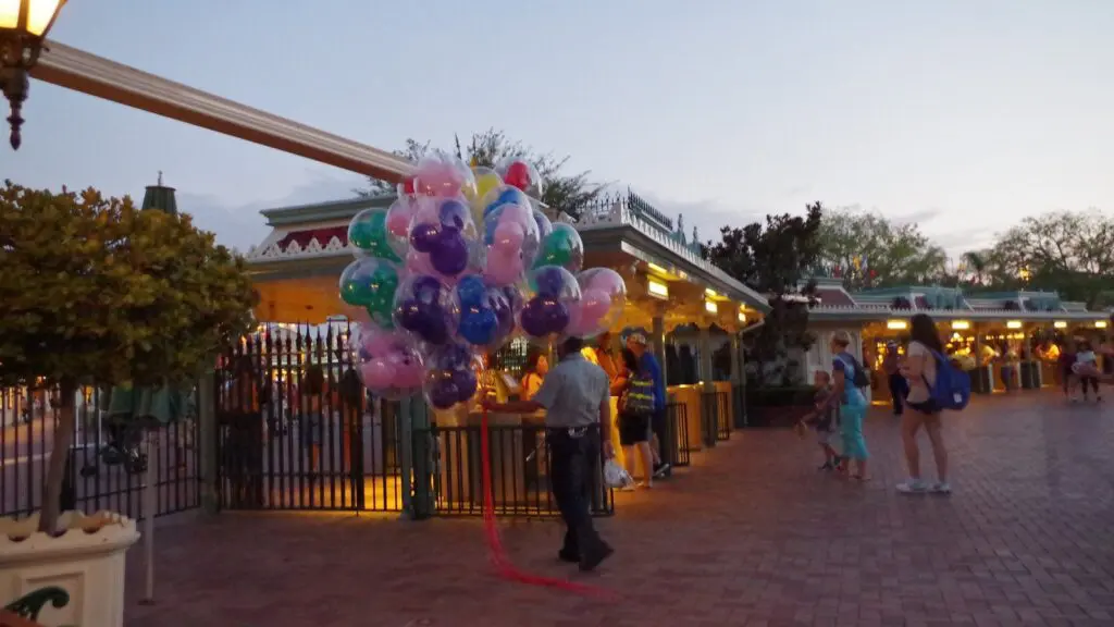 Balloon vendor near the Disneyland Park entrance gates in the evening