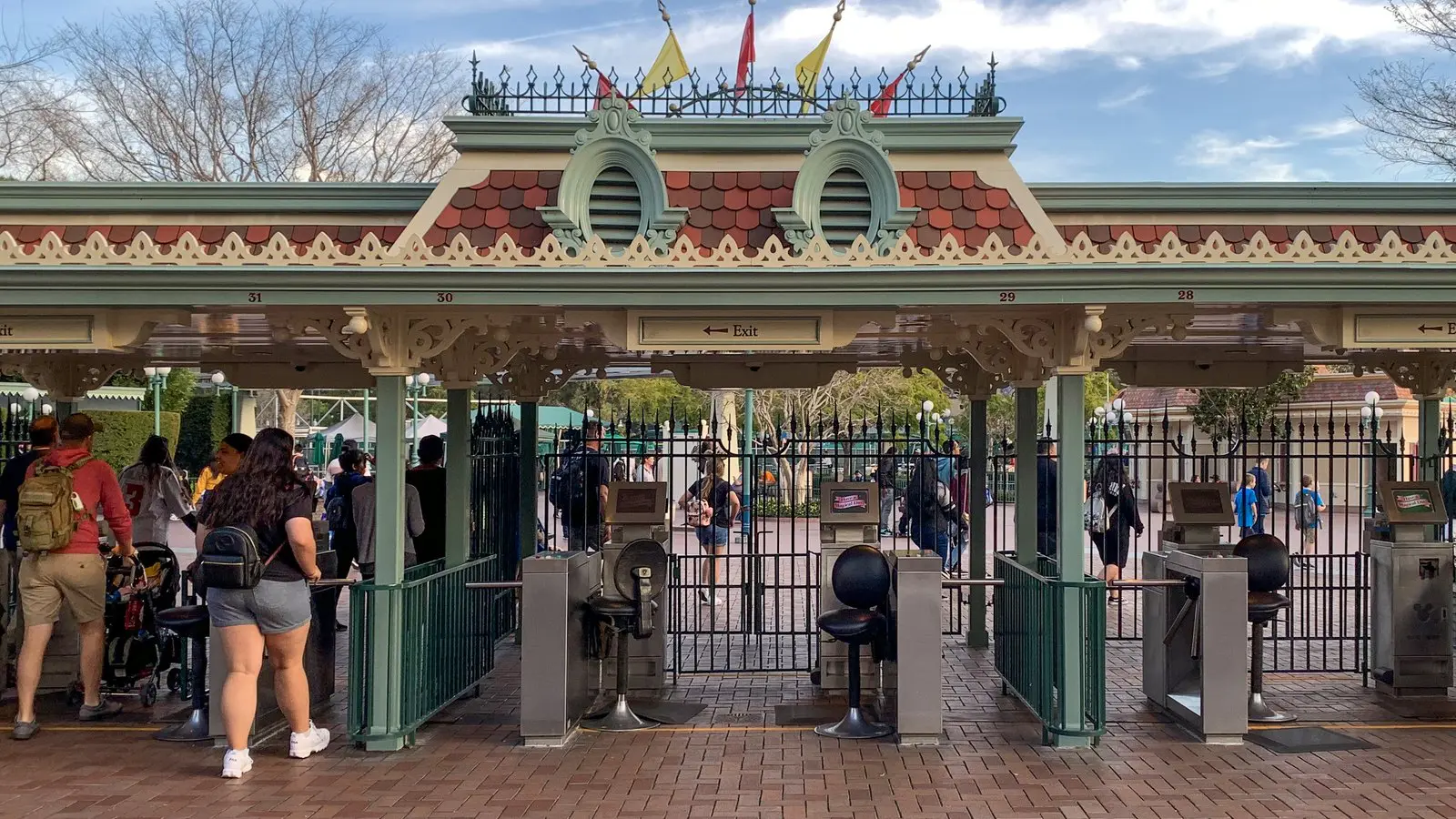 Guests passing through the Disneyland Park main entrance turnstiles in Anaheim